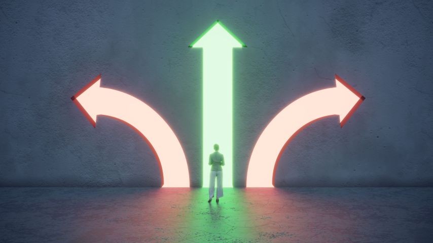 A lone figure stands before a wall with three illuminated arrows representing different paths: a bright green arrow pointing straight ahead, and two orange arrows curving to the left and right.
